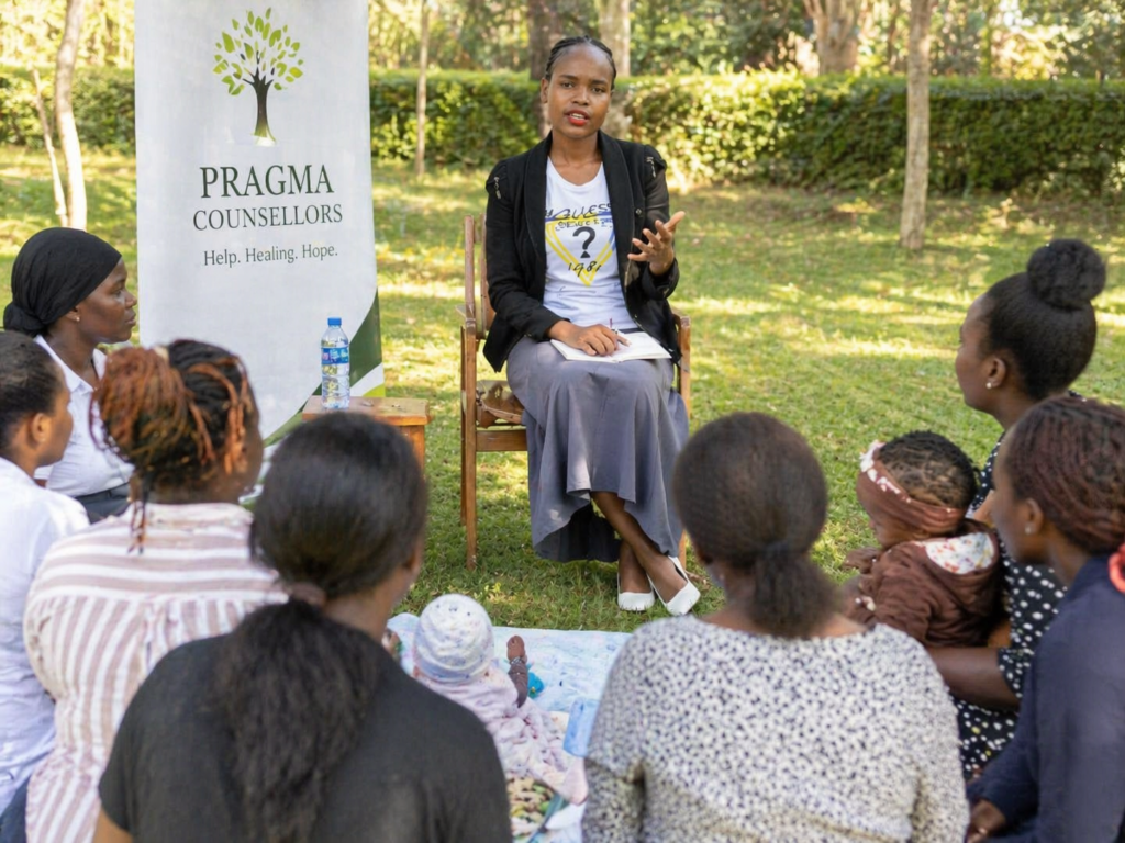 Female counsellor leading an outdoor group counselling session for young mothers at Pragma Counsellors