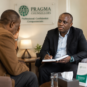 Professional male counsellor at Pragma Counsellors in Nairobi having a private therapy session with a middle-aged man struggling with depression and emotional stress.